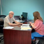 Louis Sterling with customer